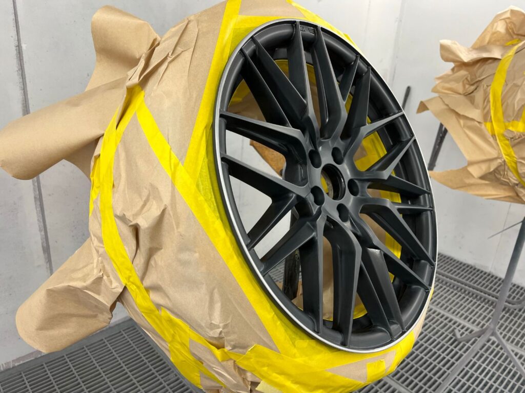 Alloy wheel masked up for refinishing in the spray booth