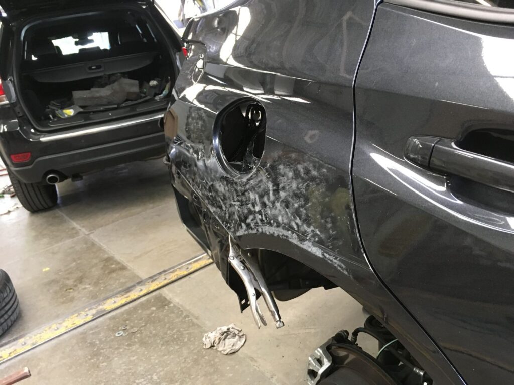 SUV with rear quarter panel damage before repair