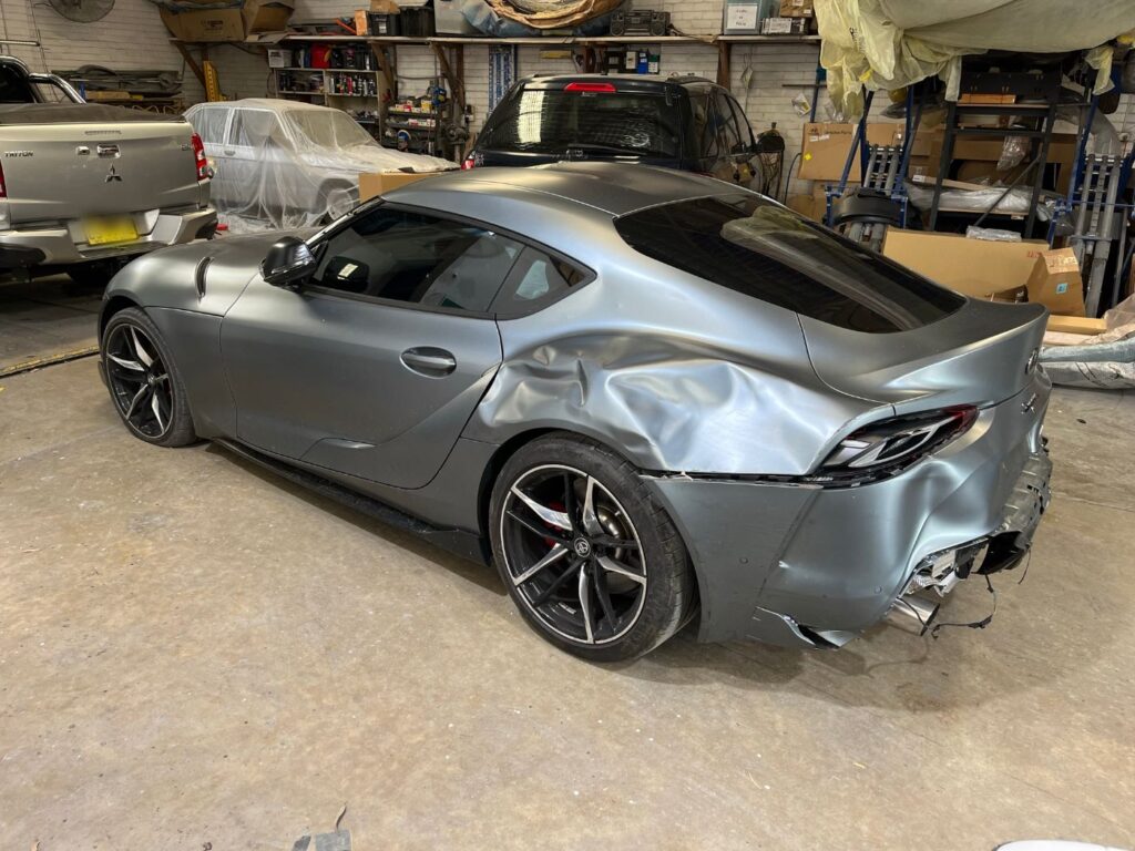 Toyota GR Supra with rear quarter collision damage before repair