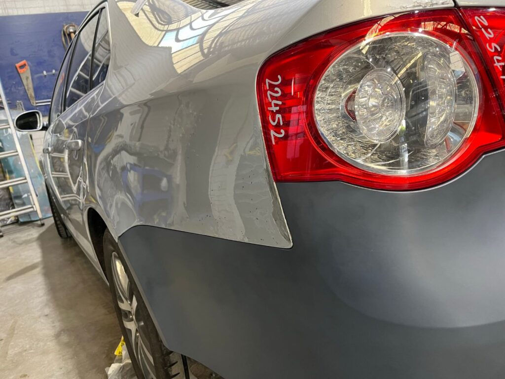 Close-up of Volkswagen Jetta rear quarter panel repair