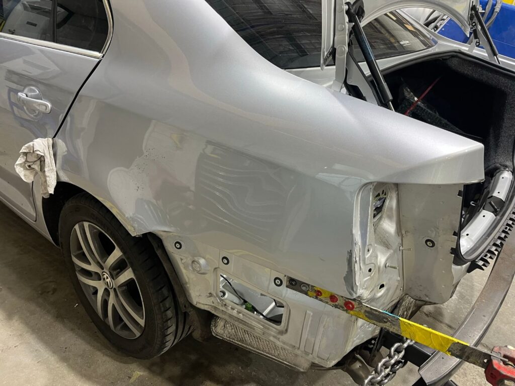 Volkswagen Jetta rear quarter panel reshaped after collision